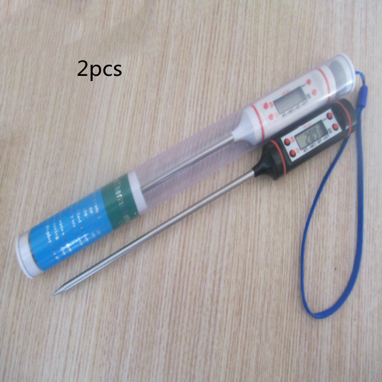 Digital thermometer with probe and packaging on a wooden surface