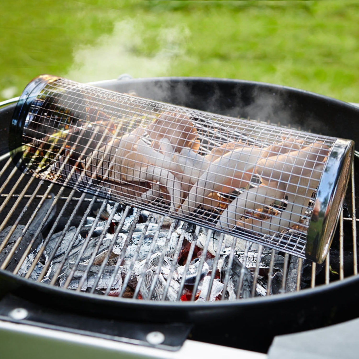 Chicken being grilled on a barbecue with a metal rack over hot coals