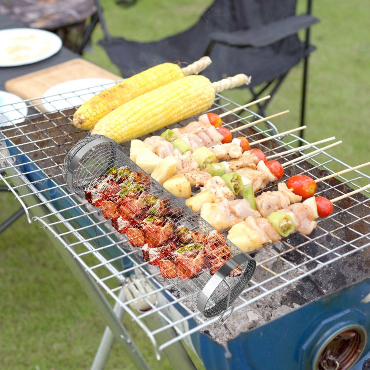 Outdoor grill with skewers of food and corn