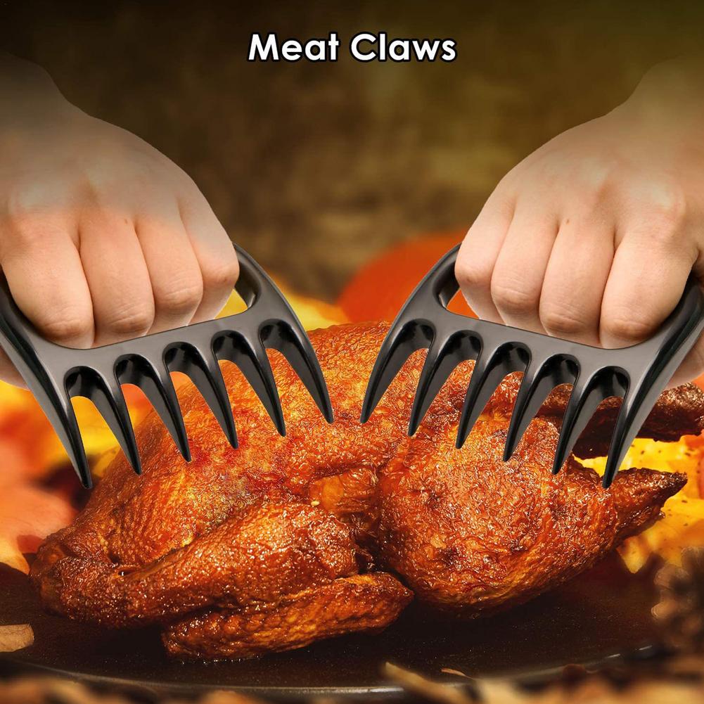 Stainless steel BBQ grilling utensil close-up showing spatula and tongs for barbecue cooking