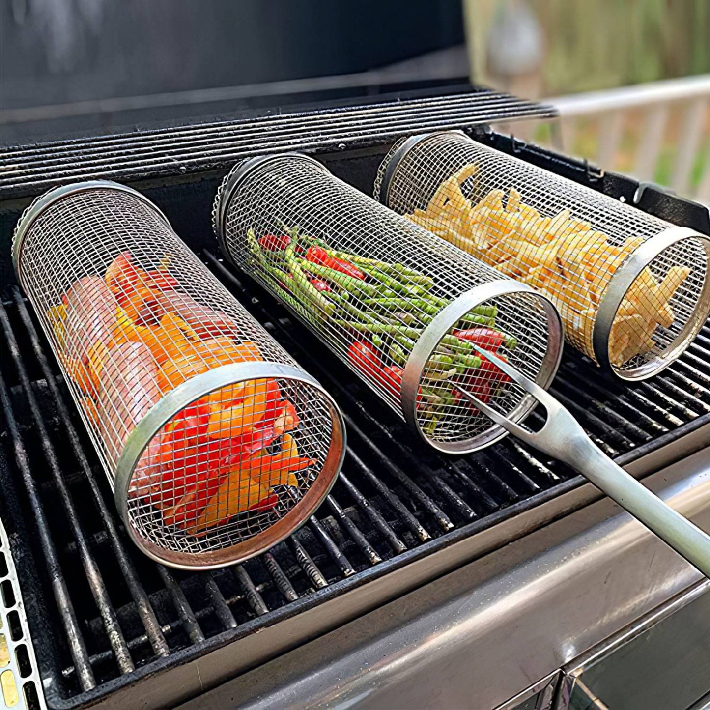 Mesh vegetable grilling baskets with vegetables on a grill