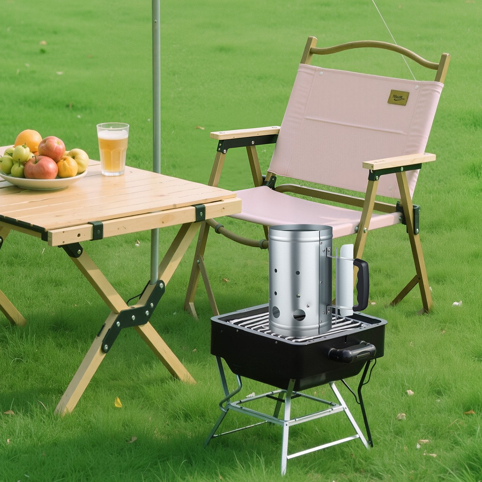 Charcoal chimney starter next to outdoor grill ready for BBQ cooking.