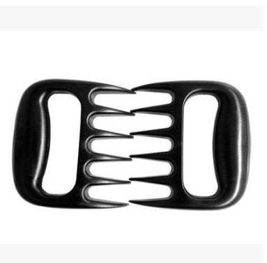 Bear claw meat shredder tool in outdoor barbecue setting for pulled meat preparation