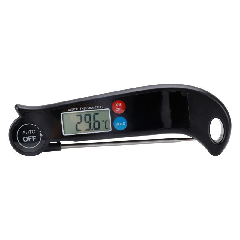 “Electronic kitchen thermometer inserted into meat on grill showing temperature reading.