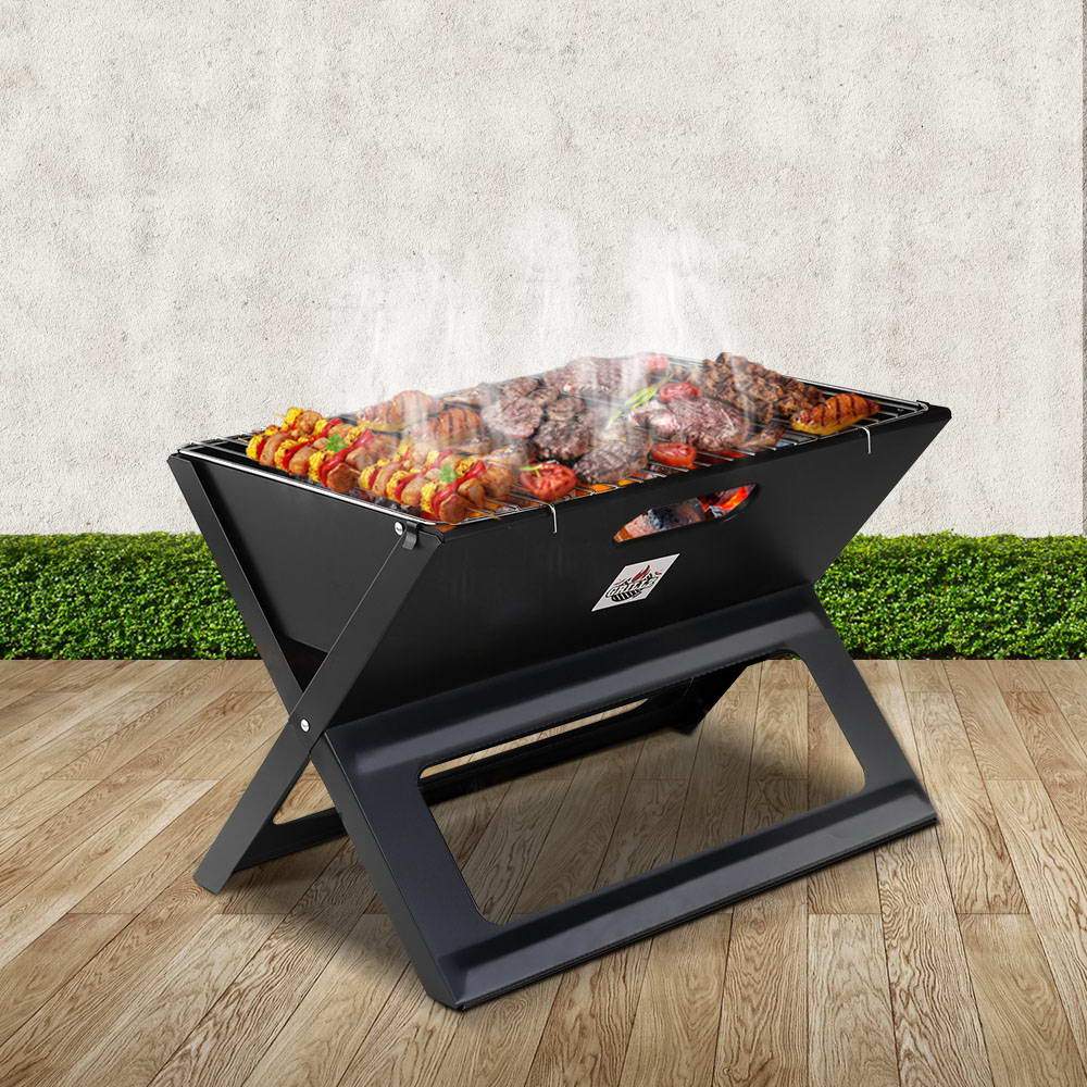 Outdoor foldable steel barbecue grill for charcoal or wood grilling